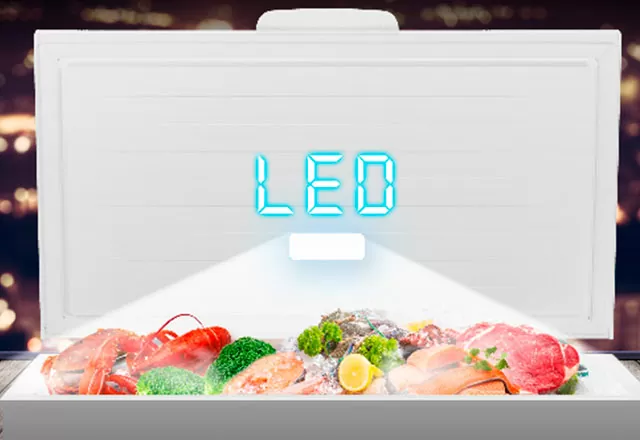 Open chest freezer with internal LED lighting illuminated. (